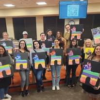 Customers Holding Art After Paint And Sip Class In Cary At Cheers N Paint Art Studio