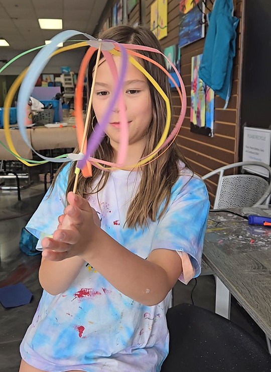 Art Camp Student At Cheers N Paint Studio In Cary, Nc Holding Colorful Art Project.