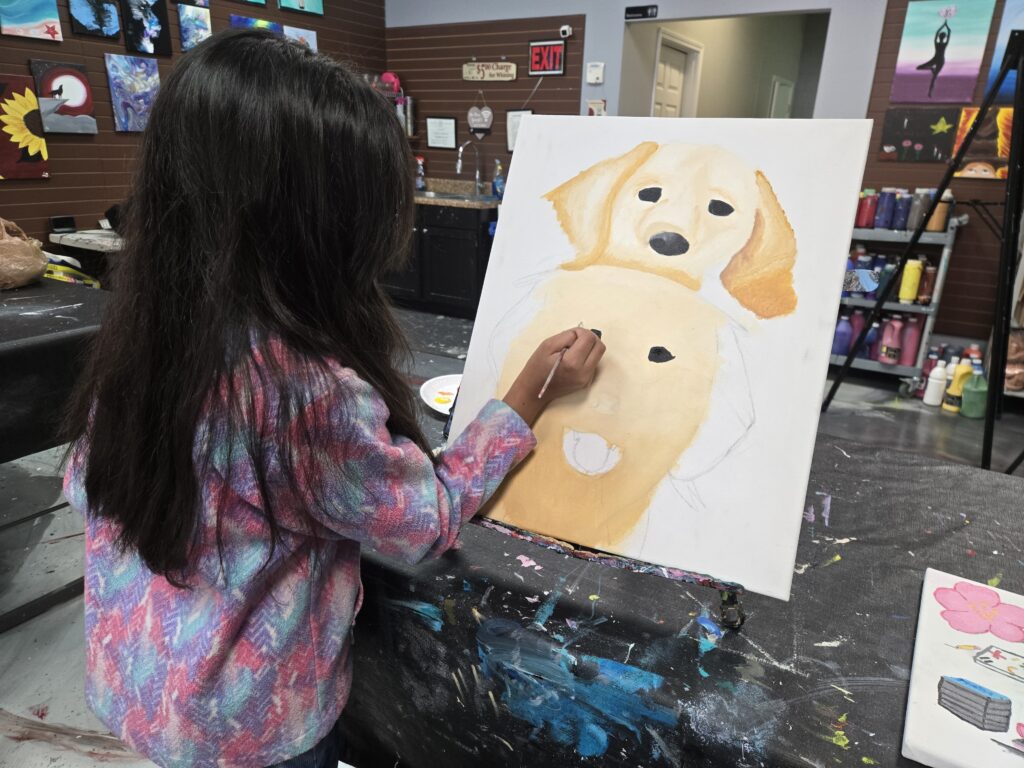 youth artist working on dog painting at Cheers N Paint art studio