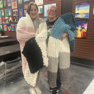 couple after making cozy knit blanket at Cheers n Paint art studio