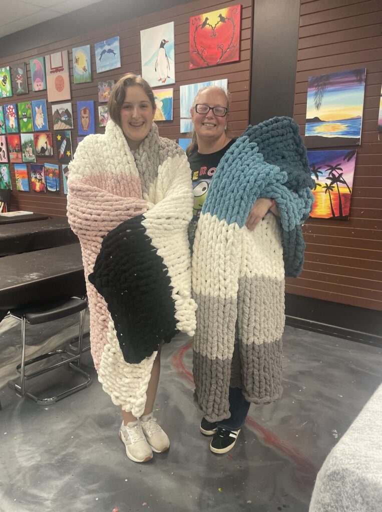 couple after making cozy knit blanket at Cheers n Paint art studio