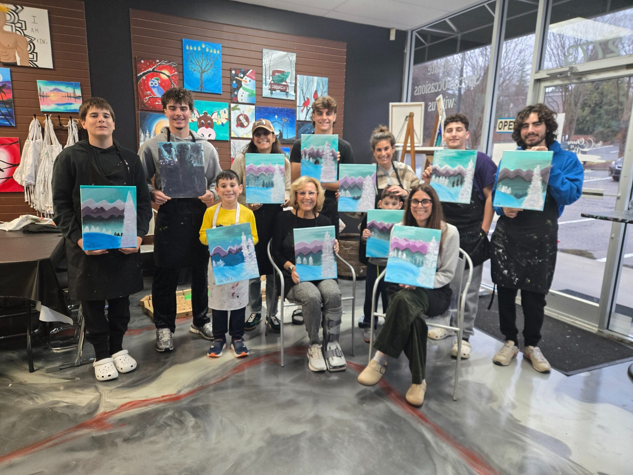 group of families at a paint n sip class in cary nc