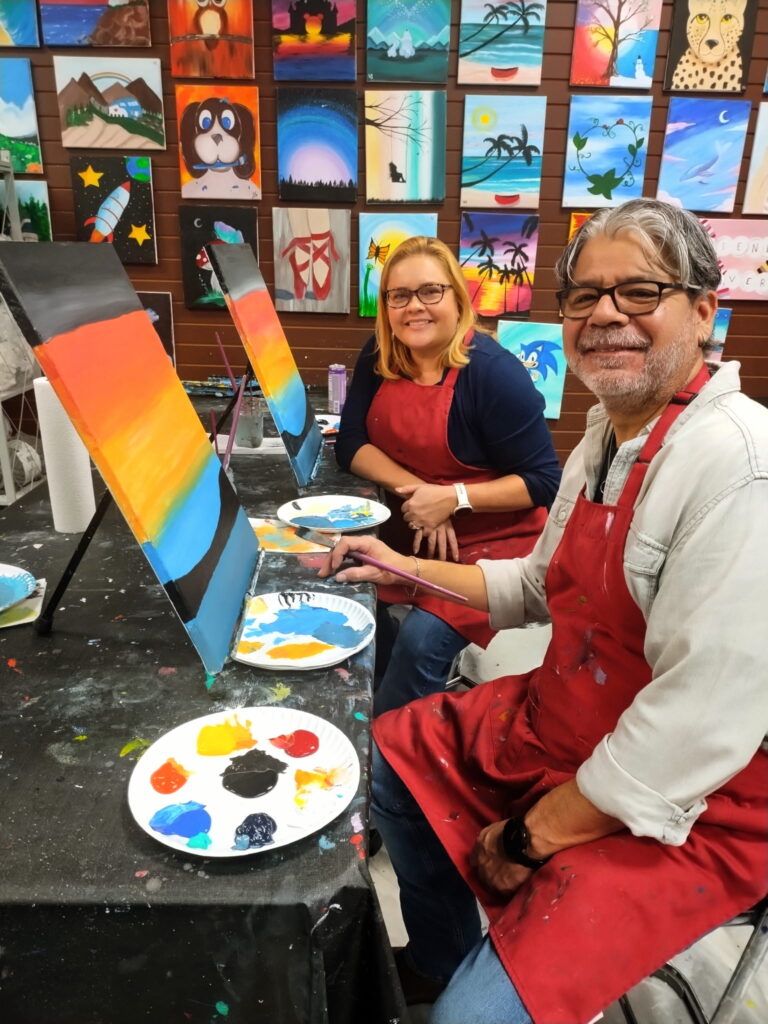 couple at cheers n paint class in Cary Nc