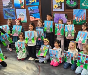 Girls art birthday party in Cary NC at Cheers N Paint, painters holding a bunny painting with friends
