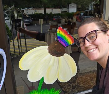 Lauren painting studio window in Cary NC