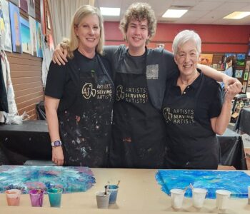 Mother and daughters at cheers n paint art studio during art class.
