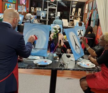 A couple painting a portrait at Valentine's Paint and Sip class in Cary, NC at Cheers N Paint art studio.